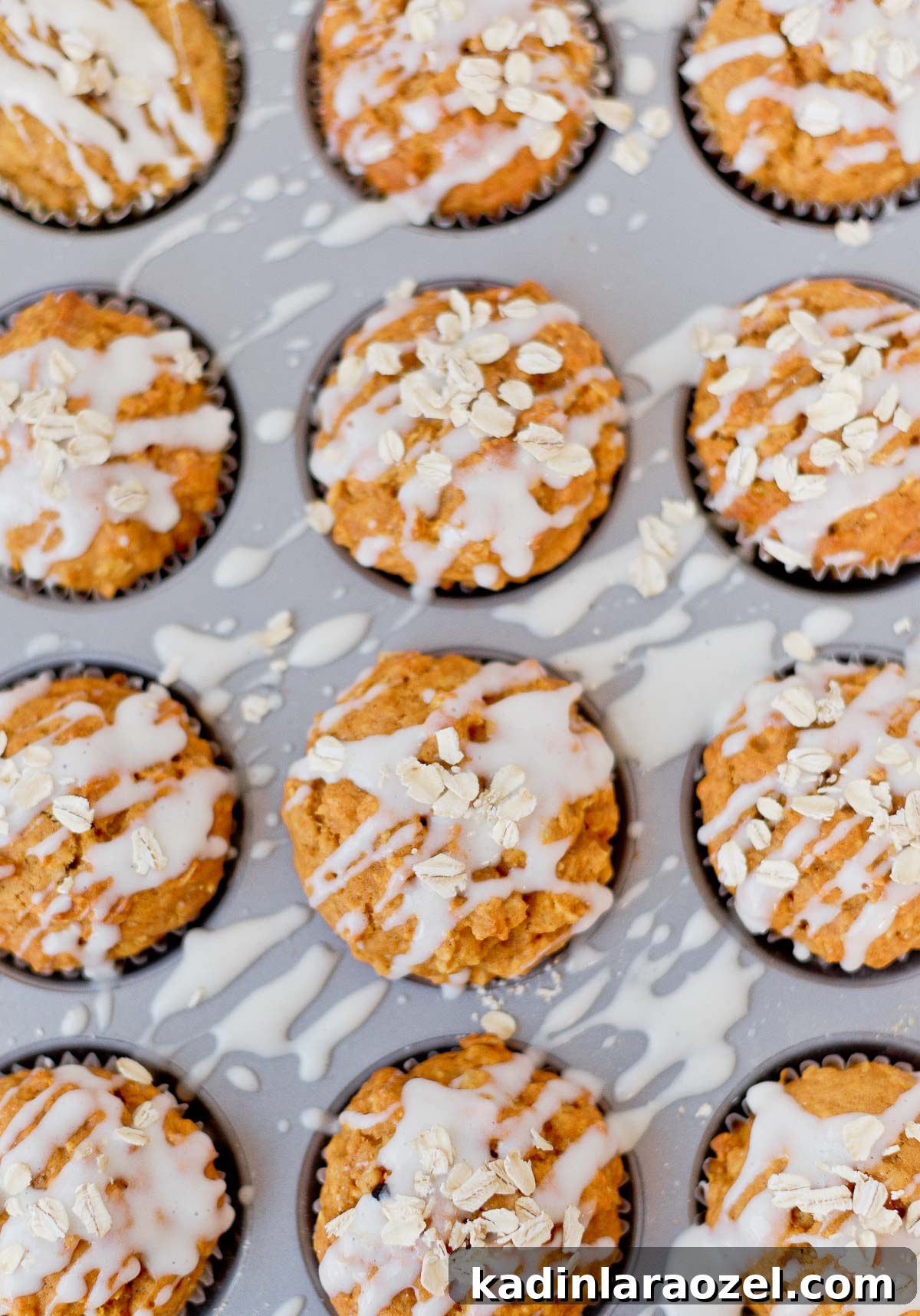 Simple Delicious Pumpkin Muffins Recipe You’ll Love 2 Pumpkin muffins with a cream cheese glaze and oats sprinkled on top.