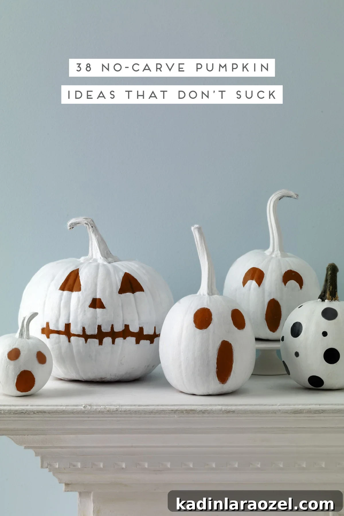 No-carve pumpkins painted white with quirky faces.