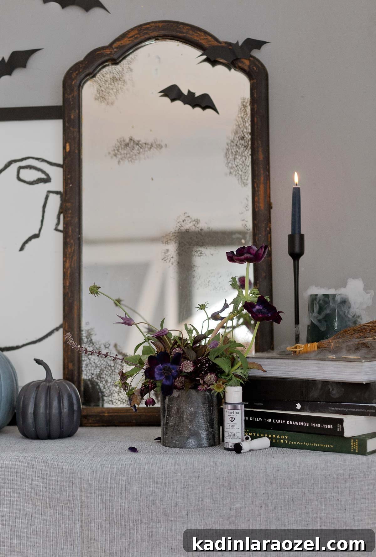 A modern take on Halloween decor with an antique DIY mirror, painted pumpkins, and more.