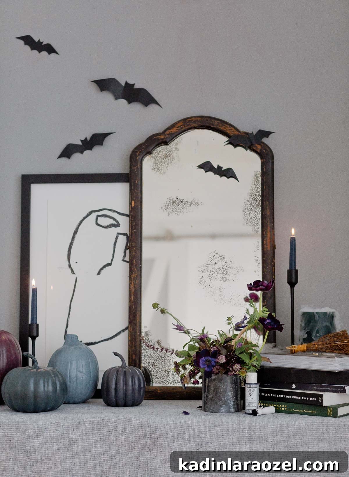 A modern take on Halloween decor with an antique DIY mirror, painted pumpkins, and more.