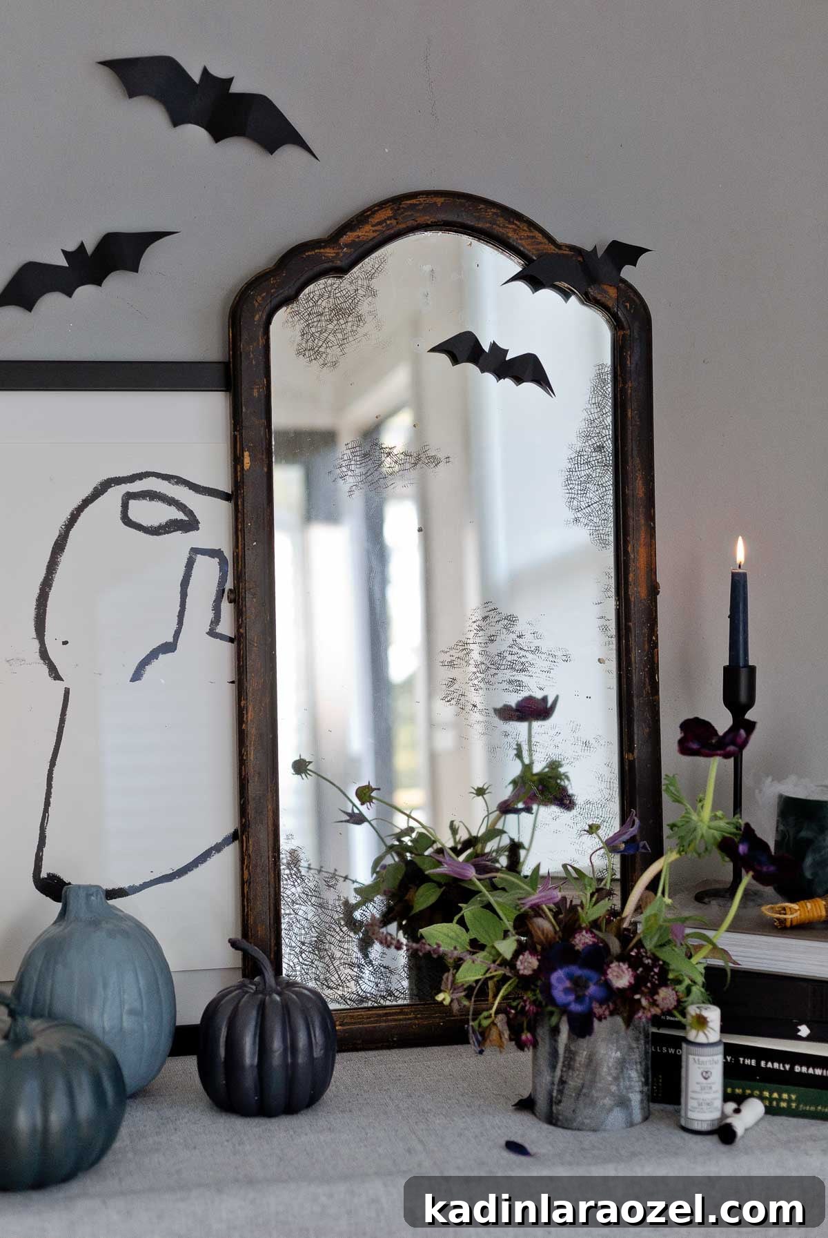 A modern take on Halloween decor with an antique DIY mirror, painted pumpkins, and more.