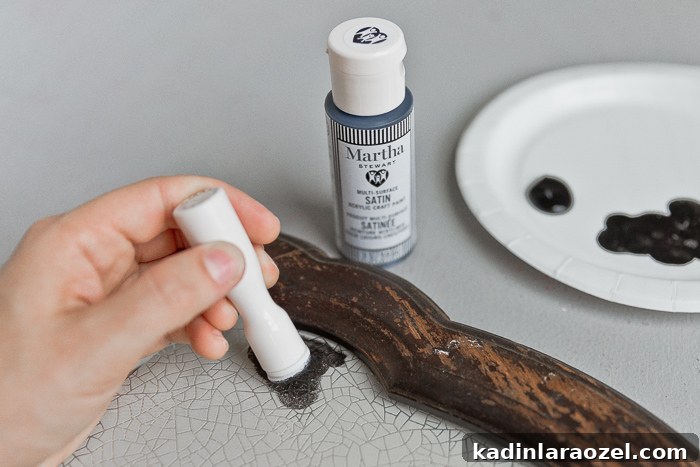 Dab paint over stencil to create antique crackle pattern.