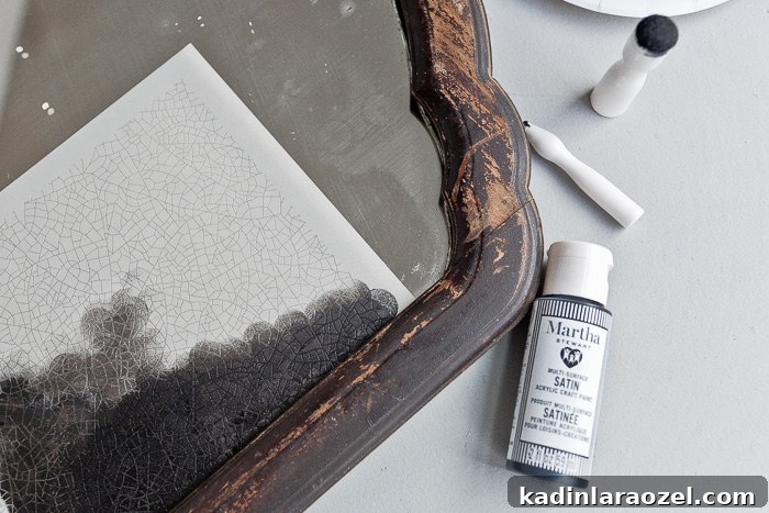 Closeup of painting stencil onto mirror.