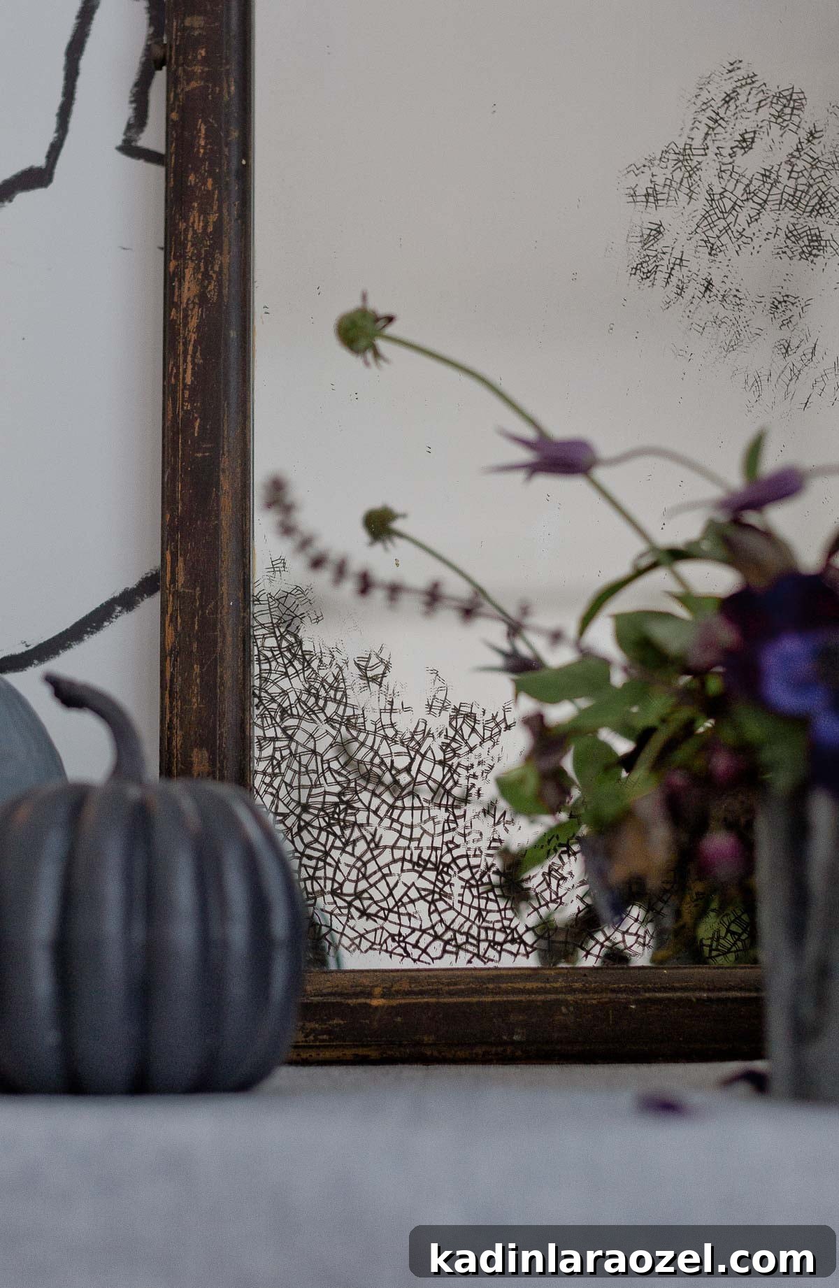 Detail photo of antique stenciled mirror for Halloween.