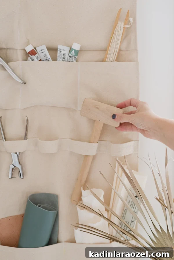 Organizing craft supplies in DIY wall organizer made of heavyweight canvas