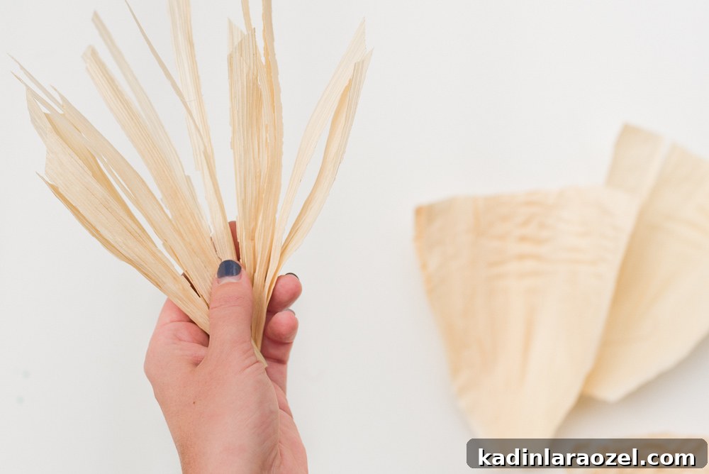 Creating fall fringe with corn husks for a fall wreath.