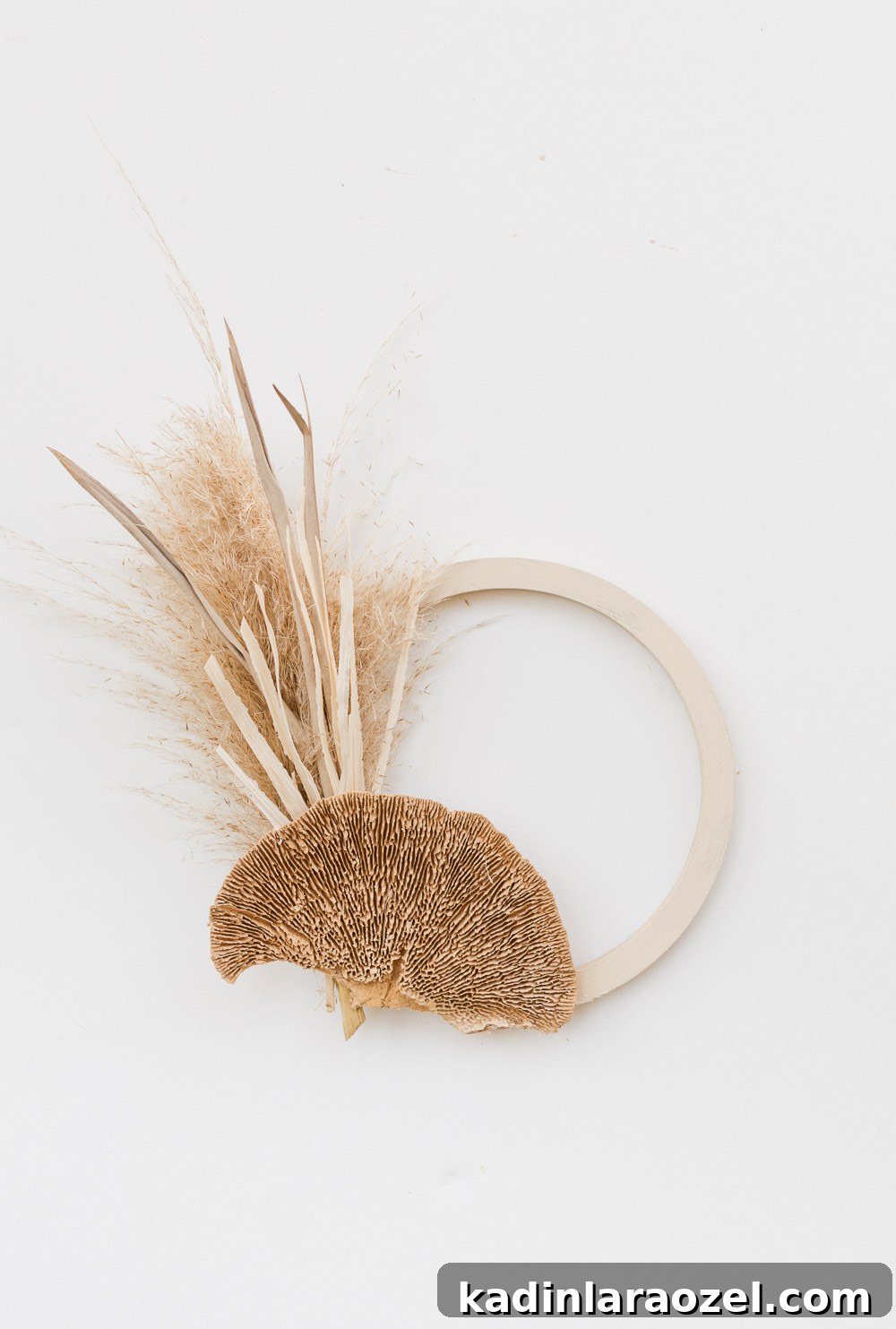 Small fall wreath made of dried mushrooms and pampas grass.
