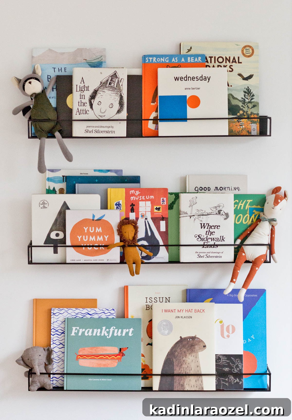 Creative Ways to Style Kids' Bookshelves for a Playful Room 5 3 wall shelves in a kids room, featuring colorful children's books and some small stuffed toys