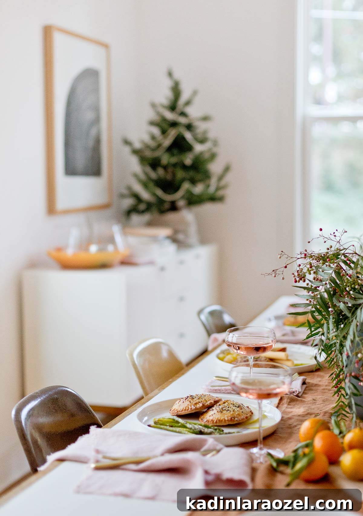 Holiday dinner tablescape with food and drinks, rust and pink colored table linens.