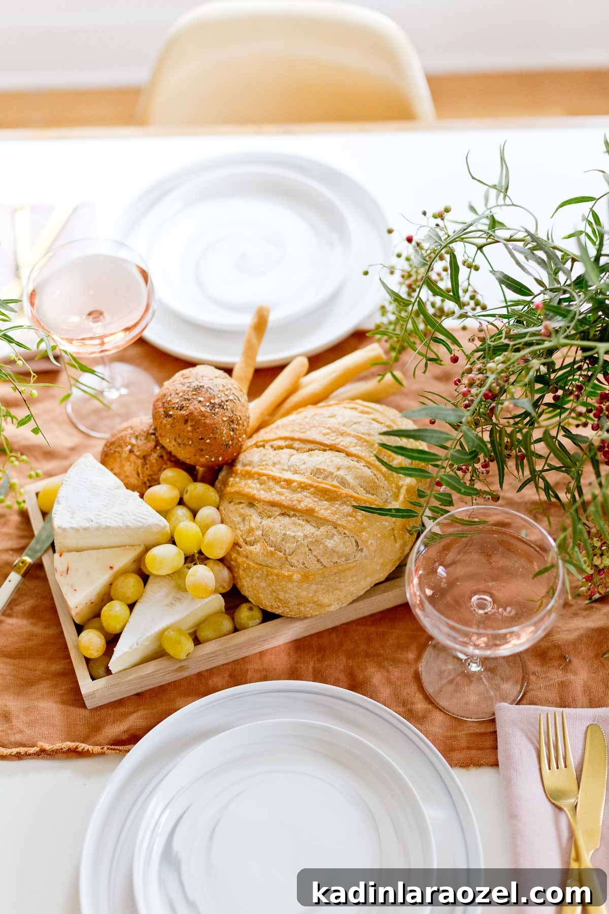Bread and cheese tray with grapes and wine