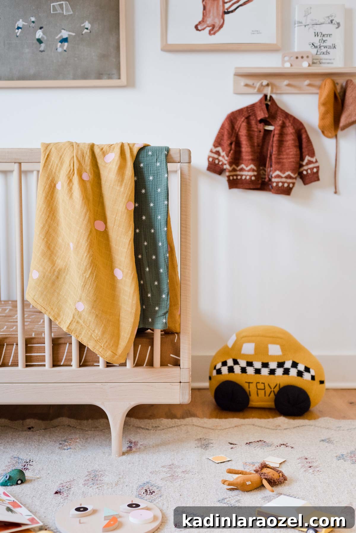 Gender neutral nursery with colorful blankets hanging over crib