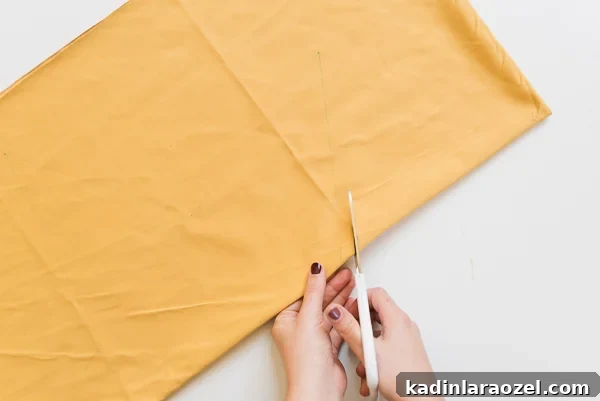 Cutting metallic gold fabric to make a star pillow