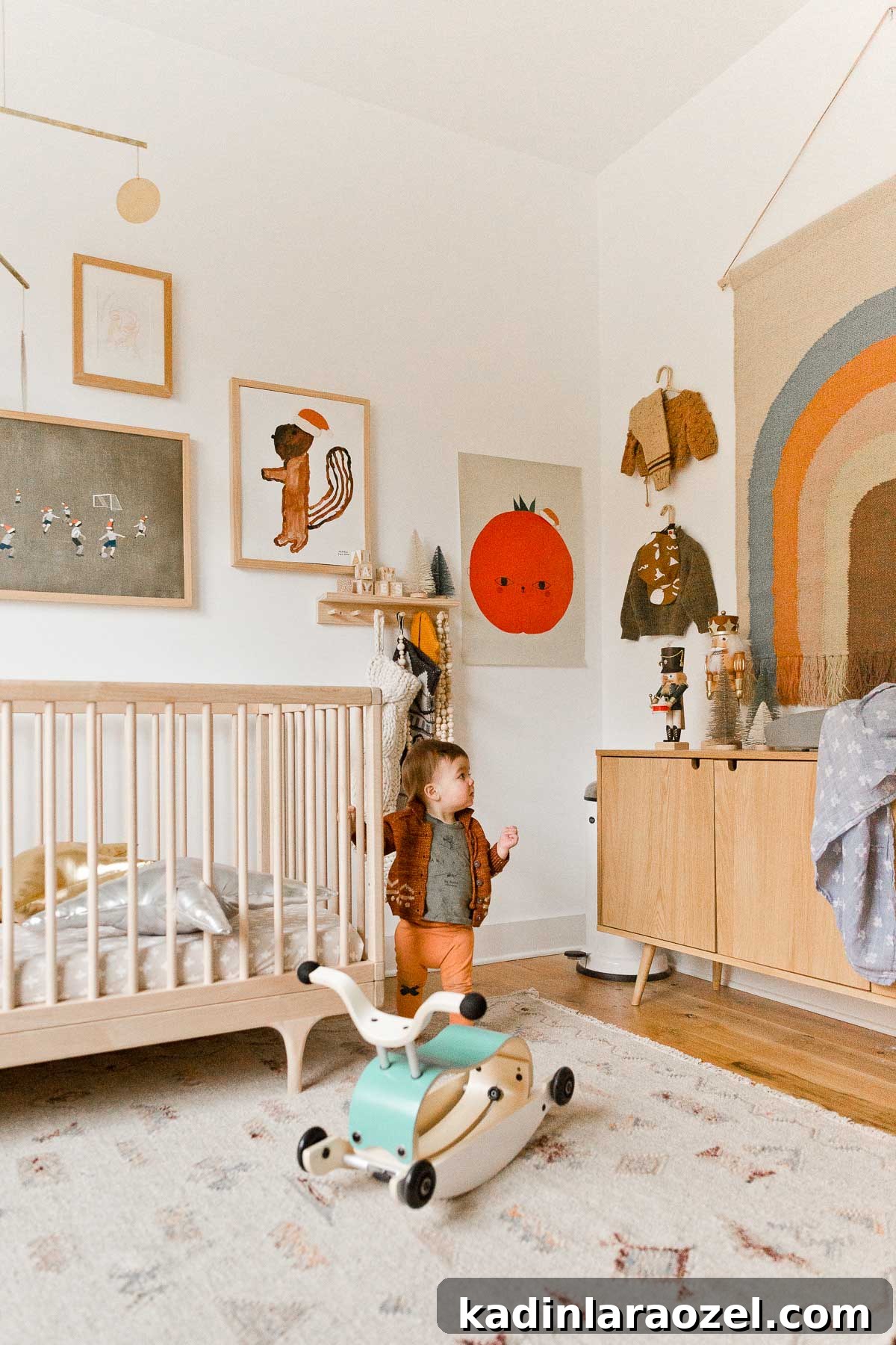 Holiday Nursery Decorating Ideas + Big Baby & Kids Holiday Gift Guide 12 A simple, neutral nursery with a few holiday touches - stockings hanging from a peg rail, nutcrackers on the changing table, Santa hats on the artwork, etc.