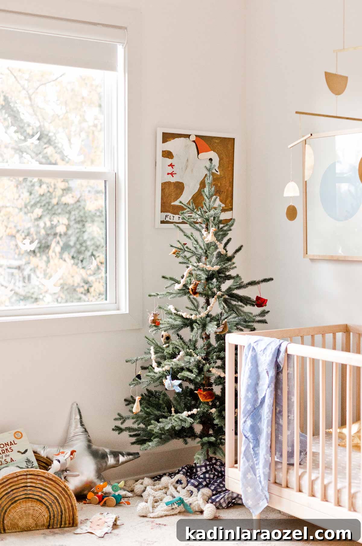 Holiday Nursery Decorating Ideas + Big Baby & Kids Holiday Gift Guide 3 I like the simplicity of this holiday inspiration - a simple Christmas tree in a kid's room or nursery, mixed with metallic star pillows and Santa hats on the artwork.