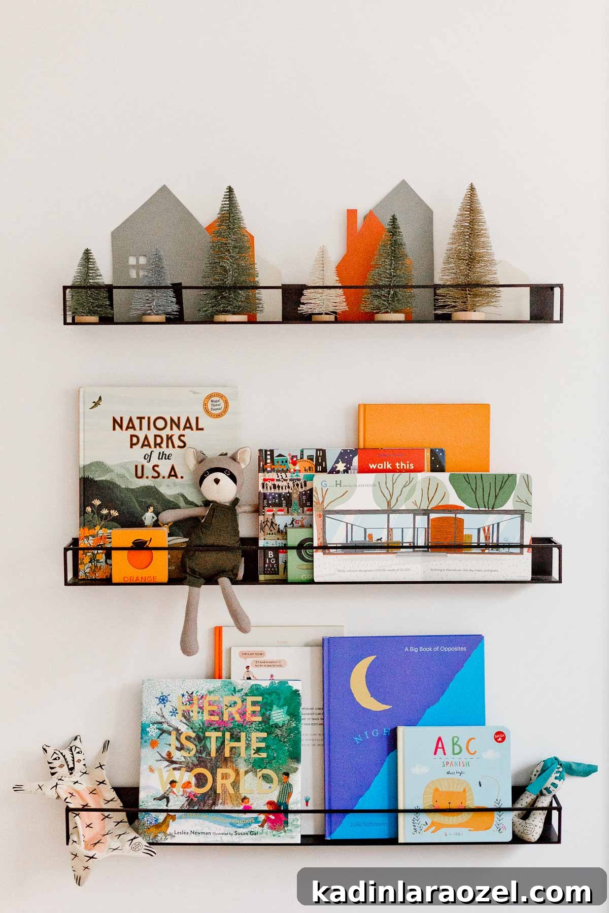 Holiday Nursery Decorating Ideas + Big Baby & Kids Holiday Gift Guide 5 A holiday inspired bookshelf for kids. The DIY paper village and bottle brush trees are a cute touch.