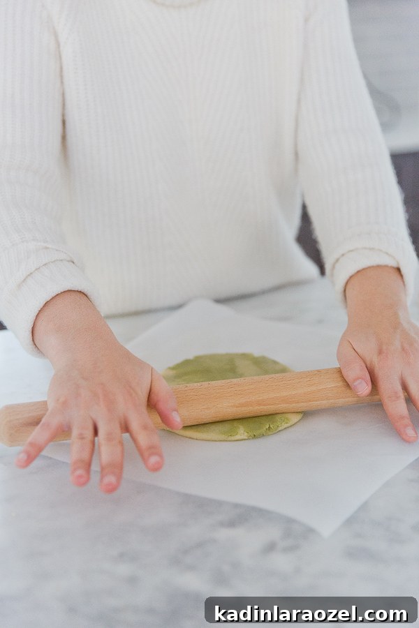 Rolling out matcha sugar cookie dough for Christmas