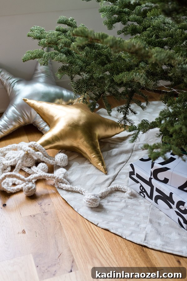Patchwork Xmas tree skirt with metallic star pillows and cozy knit garland under the tree