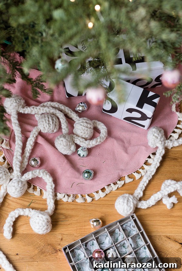 Pink Xmas tree skirt with tiny tassels and presents under the tree