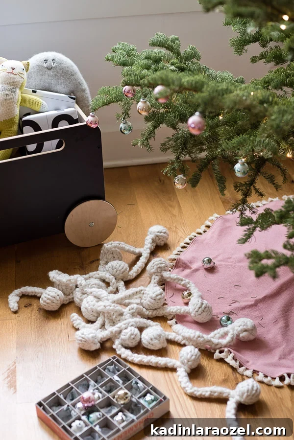 Pink DIY tree skirt with knit garland and pastel ornaments