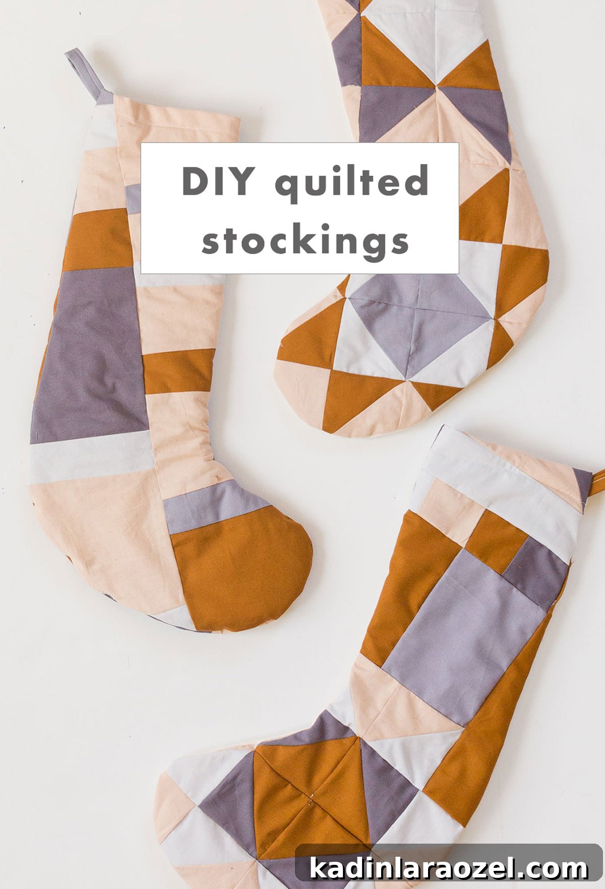 Three quilted Christmas stockings laid out on a white background.