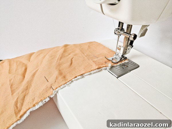 Sewing two pieces of fabric together on sewing machine to make utensil wrap.