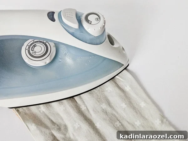 Ironing fabric to make utensil roll.