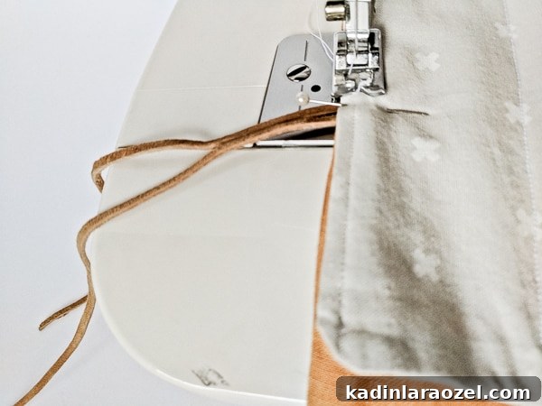 Pinning and sewing fabric together to create a DIY utensil wrap.