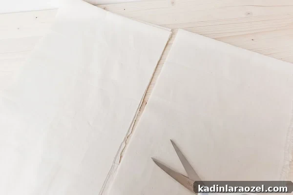 Make Reusable Produce Bags in 15 Minutes: DIY Sewing Guide 4 Cutting muslin into pieces for produce bags.