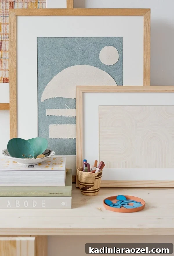DIY artwork stacked against the wall in varying neutral colors