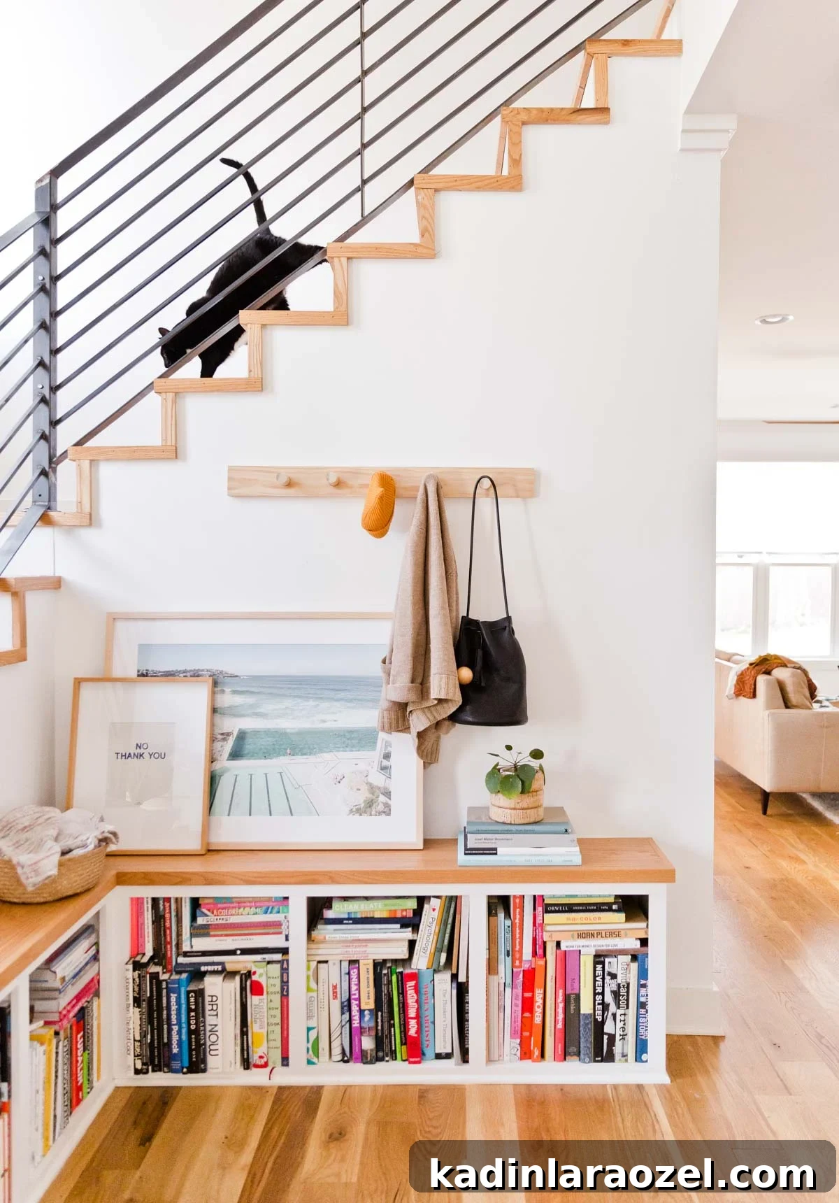 Decorate Your Home for Free: Creative Low-Cost Styling Ideas 12 minimal modern staircase with black cat walking down to landing area with photography art prints