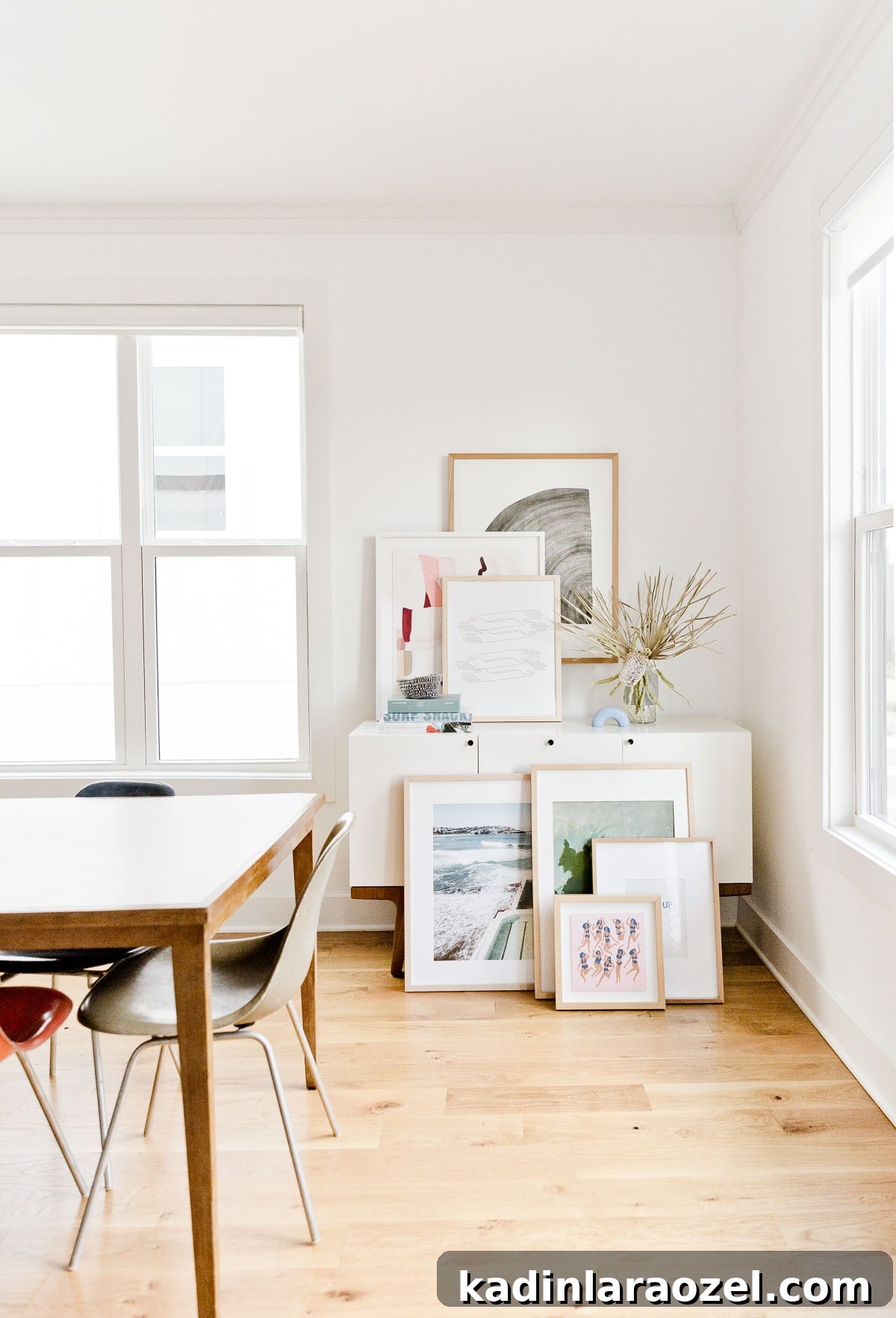 Decorate Your Home for Free: Creative Low-Cost Styling Ideas 4 dining room with white credenza and artwork stacked on top of it and below it on the floor as well