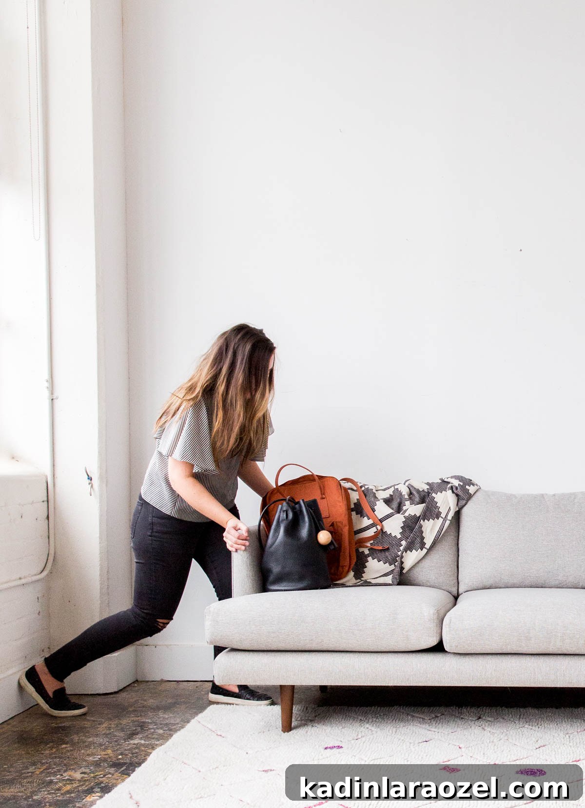 Decorate Your Home for Free: Creative Low-Cost Styling Ideas 9 woman pushing minimal modern couch into another room