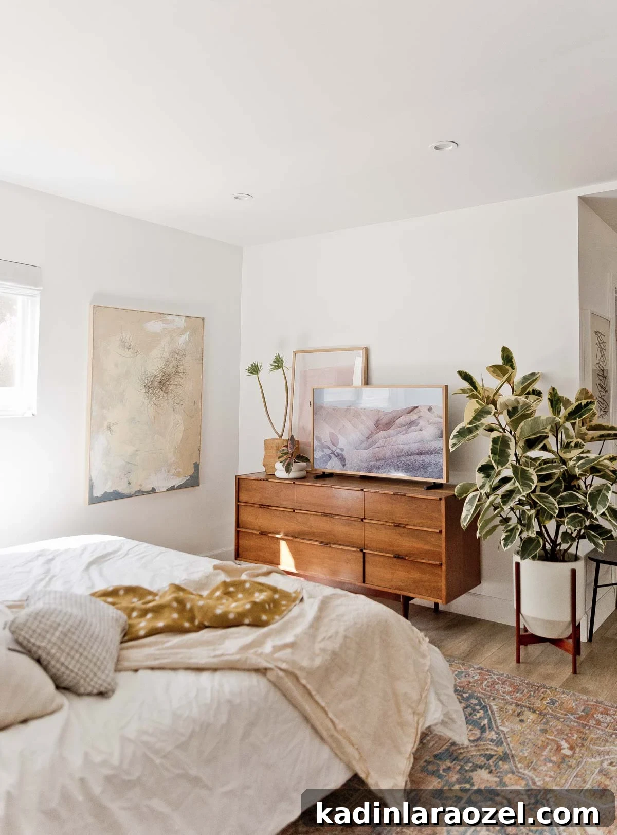 Decorate Your Home for Free: Creative Low-Cost Styling Ideas 10 earthy minimal bedroom with neutral bedding and artwork, filled with plants