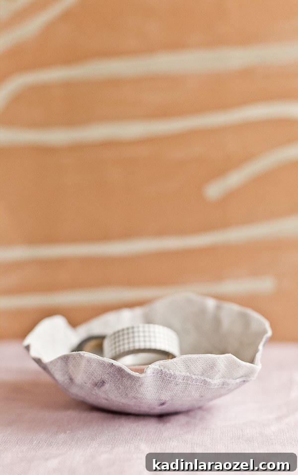 Pastel bowl made of fabric, with office supplies inside.
