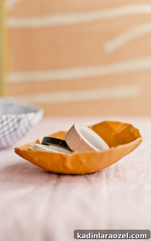 Simple fabric bowl in burnt orange color, holding wash tape office supplies.