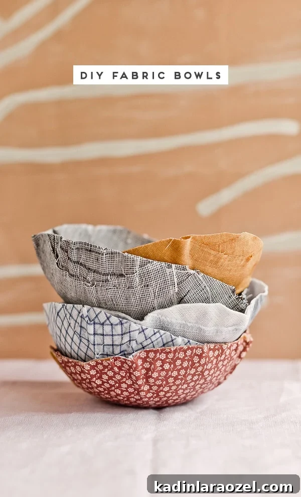 Stacked DIY fabric bowls on a table with abstract wallpaper backdrop.