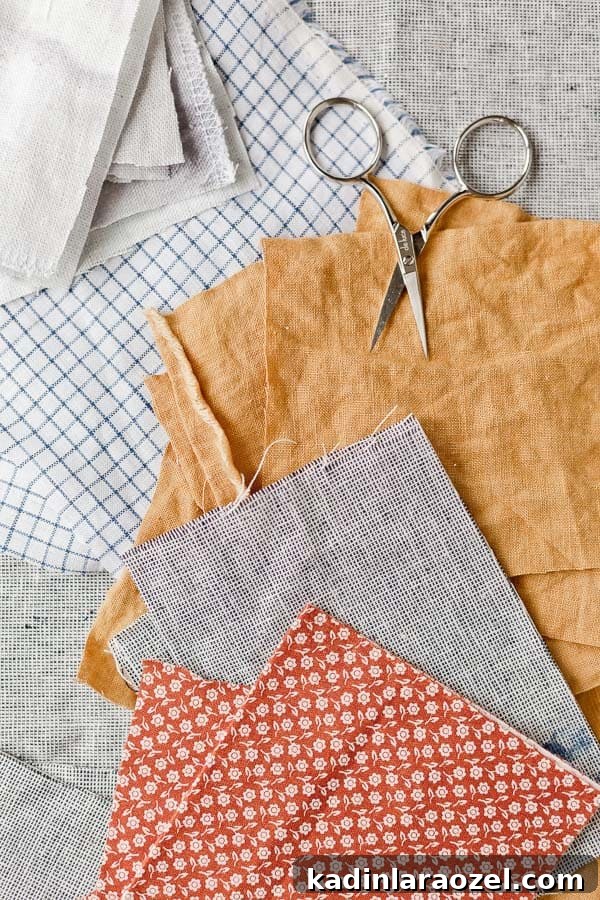 Fabric scraps on a table with scissors.
