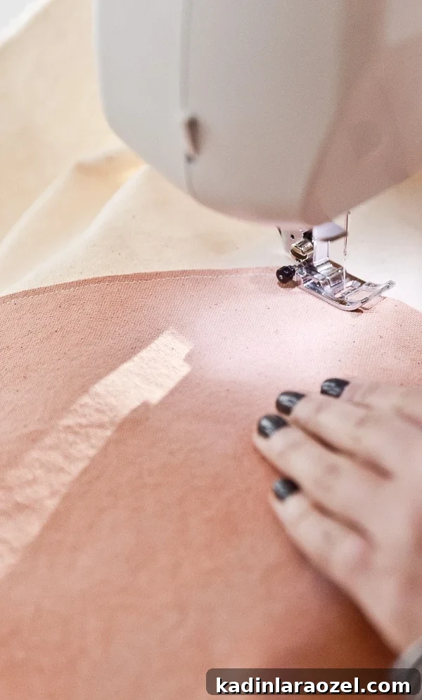 Sewing canvas together to create large scale artwork.