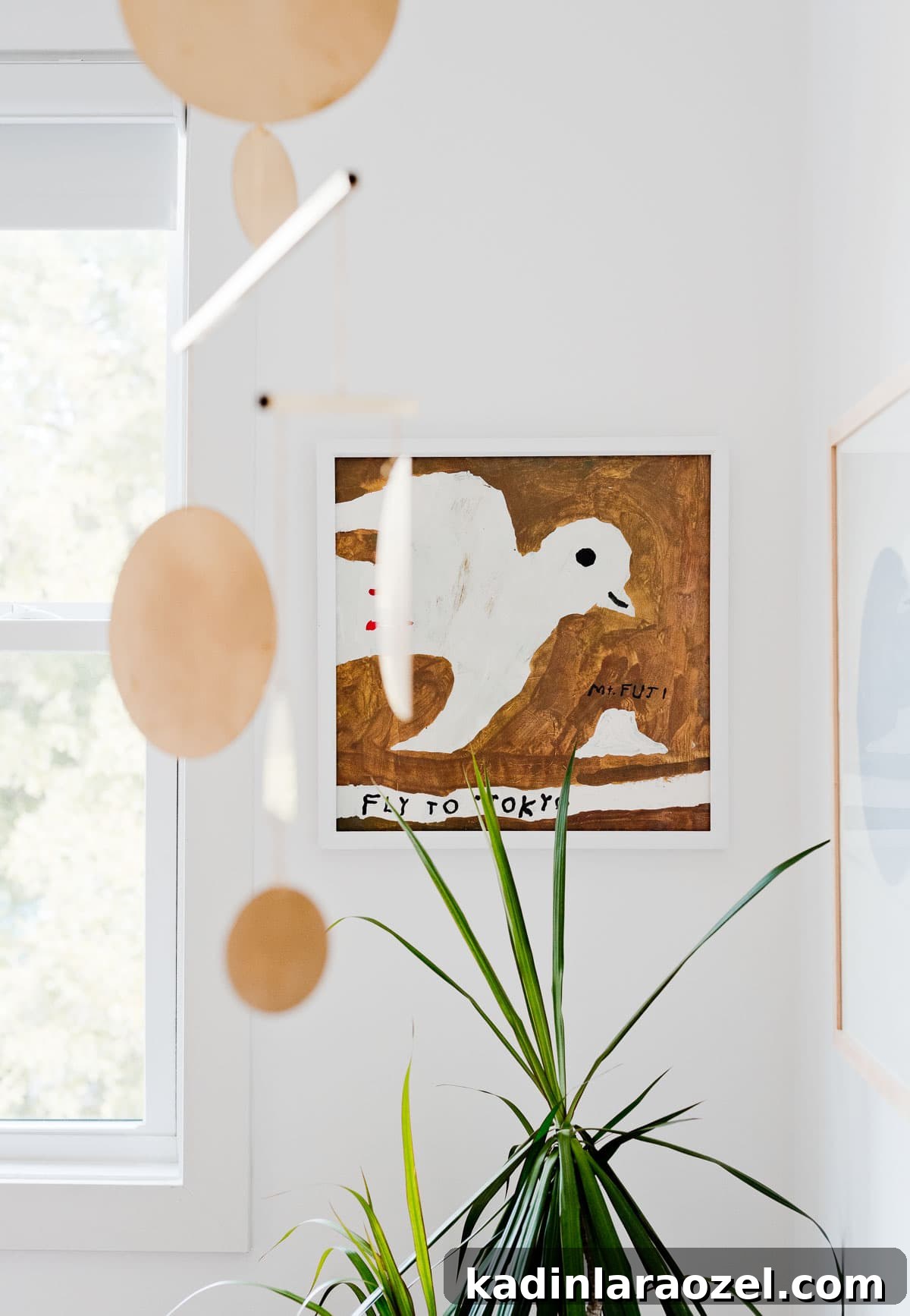 Where to Buy Art: Top Places to Find Original Artwork 3 Painting of a bird that says 'fly to Tokyo', hanging in a child's nursery.