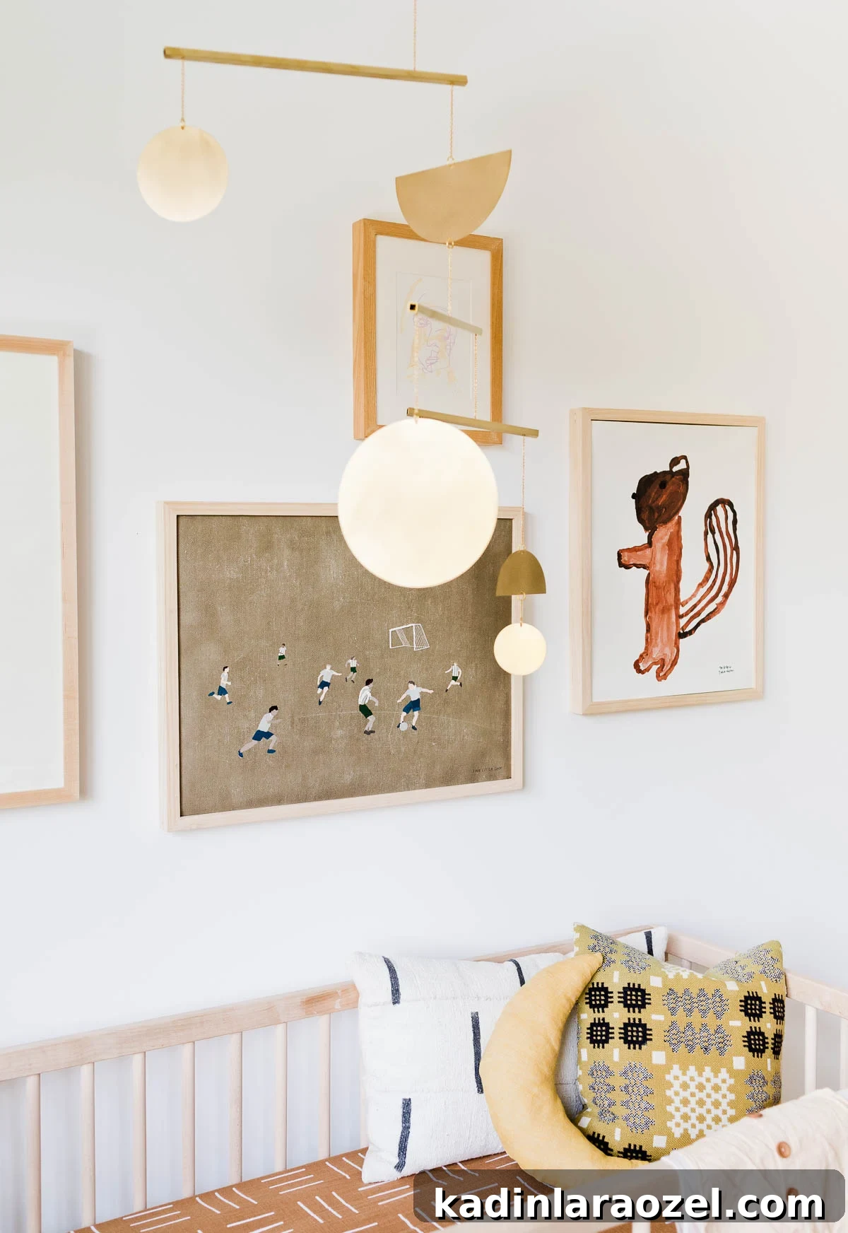 Where to Buy Art: Top Places to Find Original Artwork 5 Gallery wall of artwork hanging over modern crib in a neutral nursery.