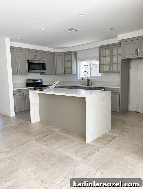 We Moved to California — Before Photos and Home Tour Updates 4 Before photo of grey cabinet kitchen, with white countertops.