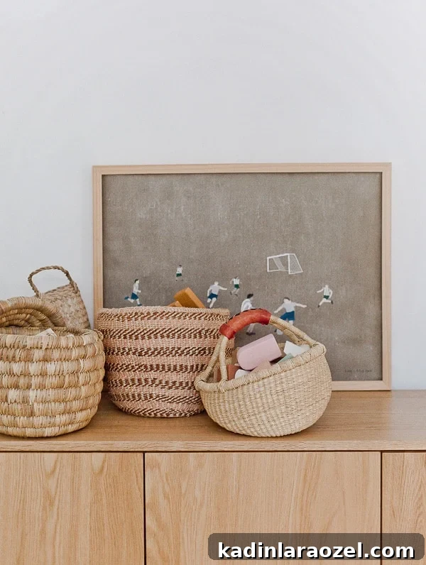 Where to Find Stylish Woven Storage Baskets Online and In-Store 2 Woven baskets of various sizes, sitting on a credenza with a piece of art behind it.