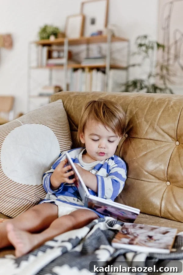 Create a Personalized Baby Board Book: 3 Creative DIY Methods 2 Photo of toddler reading a board book on the couch.