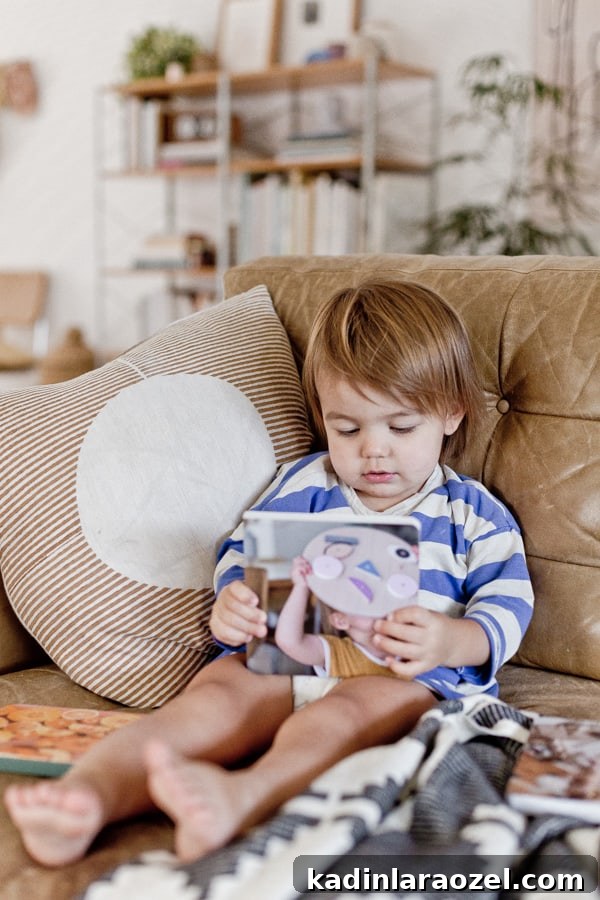 Create a Personalized Baby Board Book: 3 Creative DIY Methods 12 Photo of toddler reading a small book on the couch, about toys.