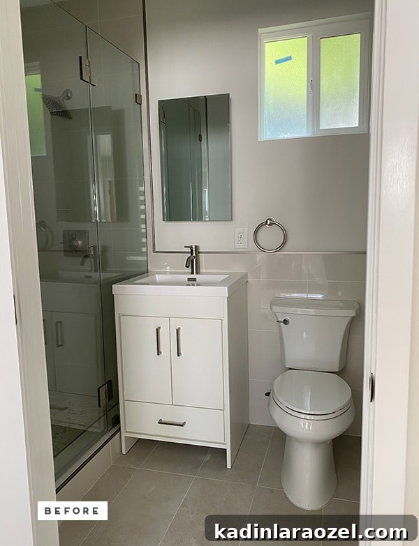 Yellow Bathroom Reveal: Stylish Renter-Friendly Makeover 4 Photo of 'before' basic builder grade bathroom with white vanity and toilet.