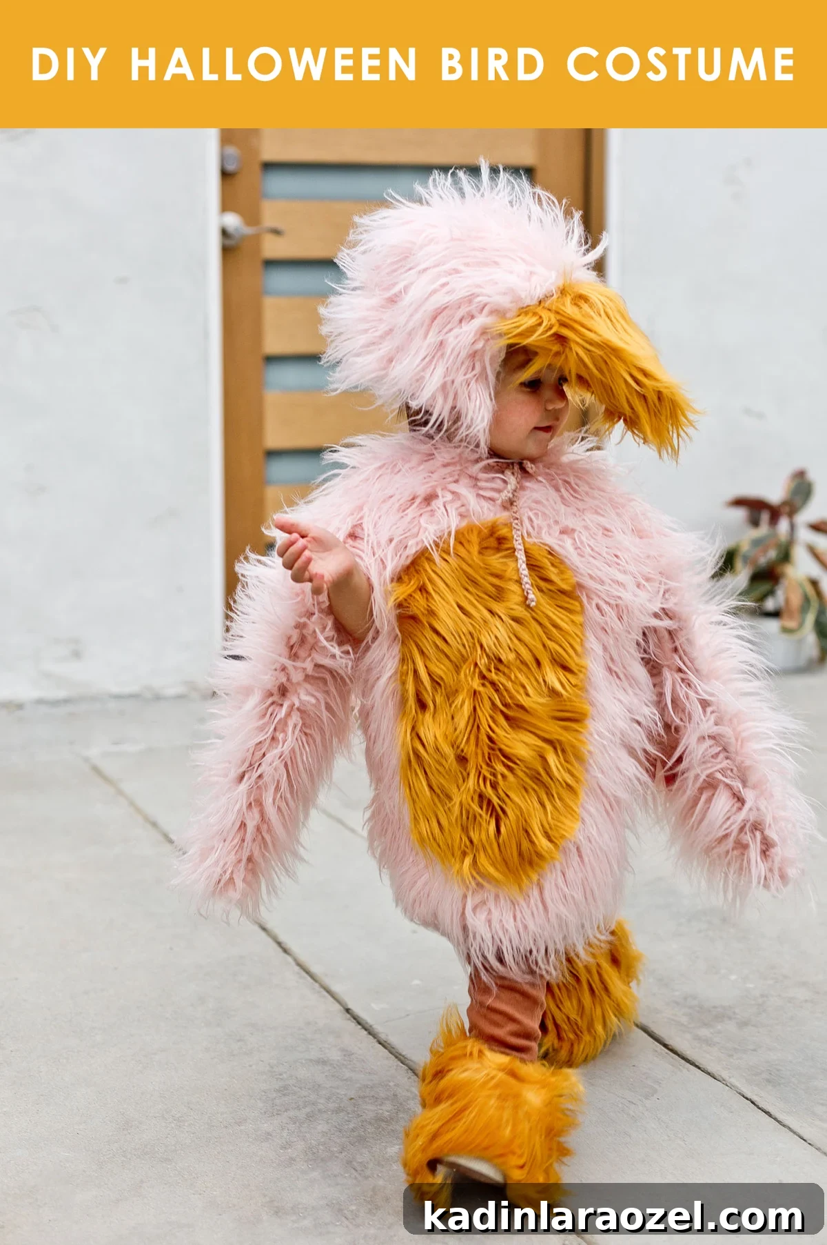 Child wearing pink and yellow homemade bird costume