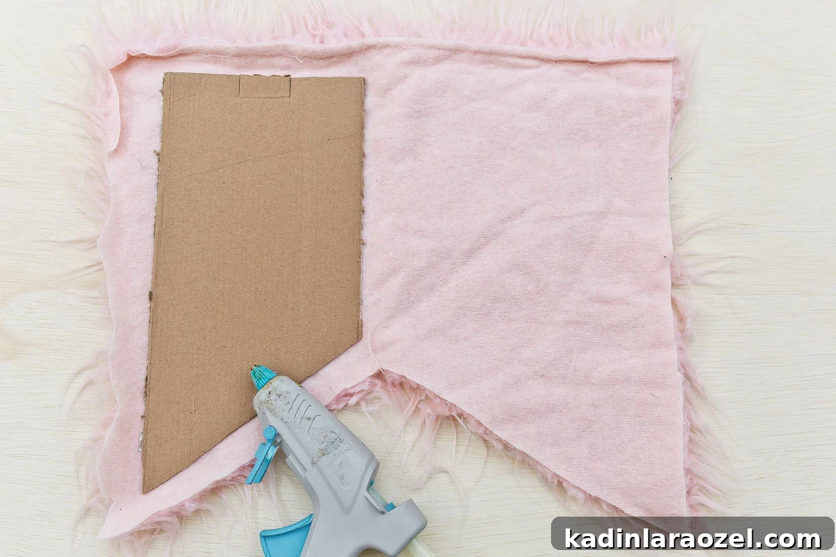 Pink faux fur and glueing cardboard to wings for bird costume.