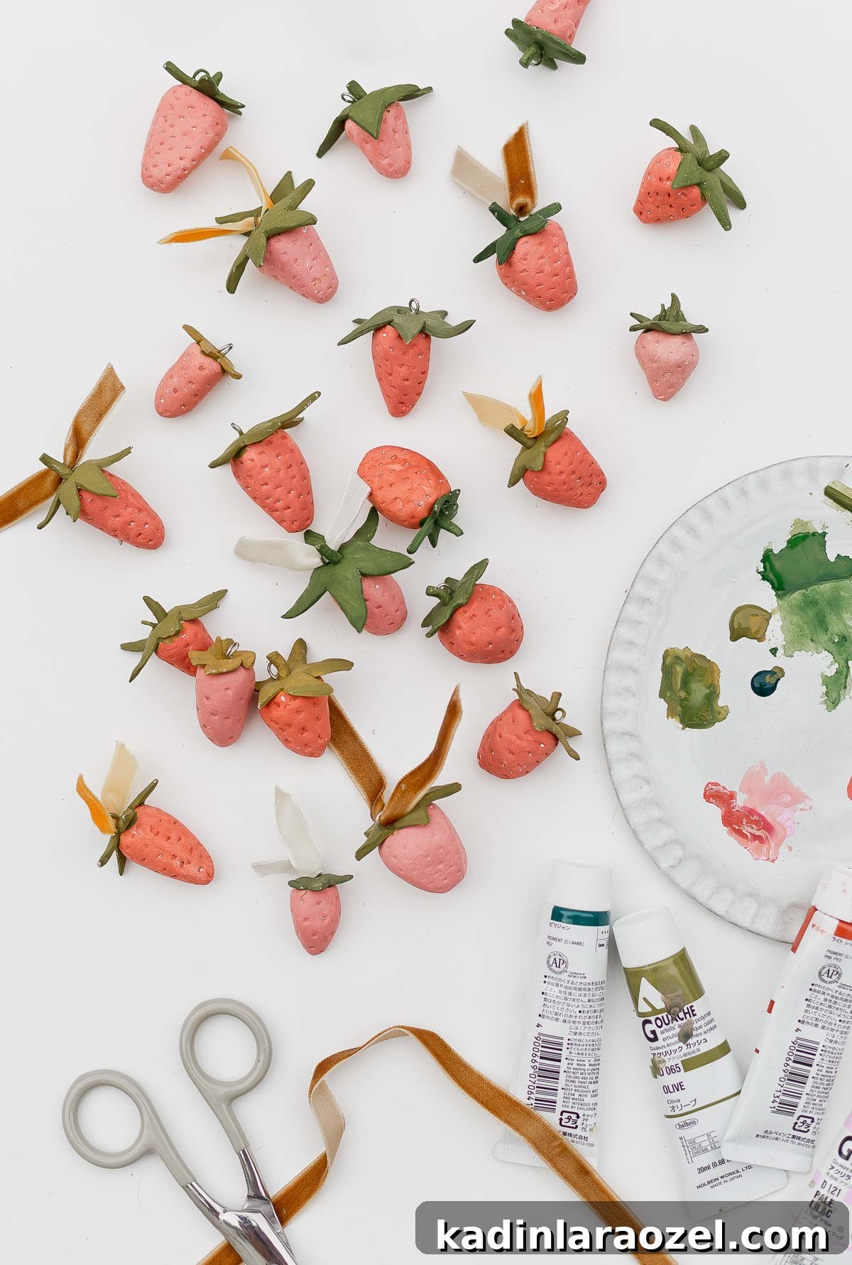 Clay strawberries with paint palette nearby.