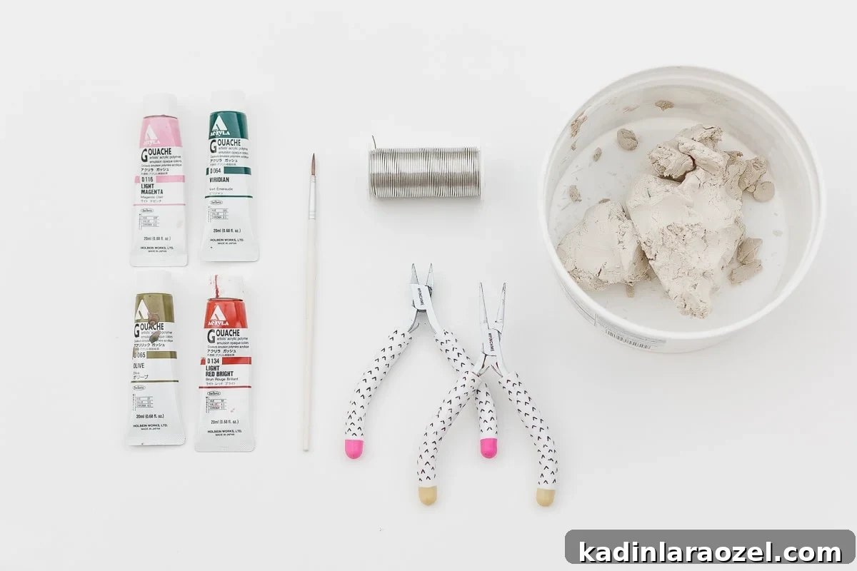 Materials needed to make DIY clay strawberries.