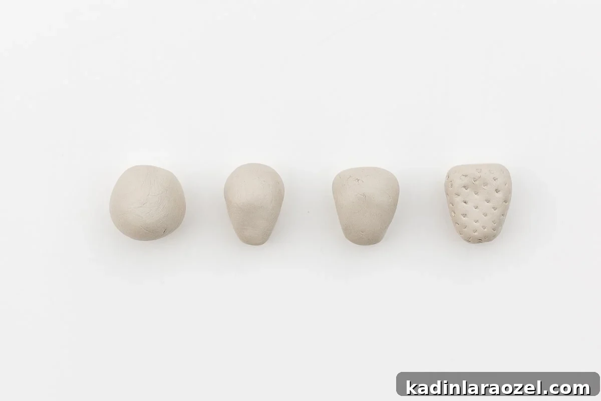 Phases of making a clay strawberry.